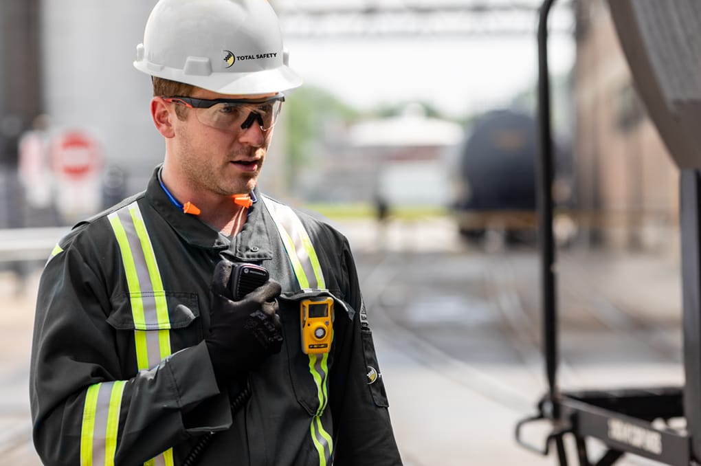 Safety Technician Communicating Via 2-Way Radio