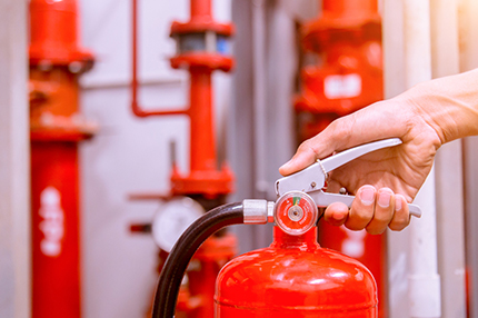 Hand On a Fire Extinguisher