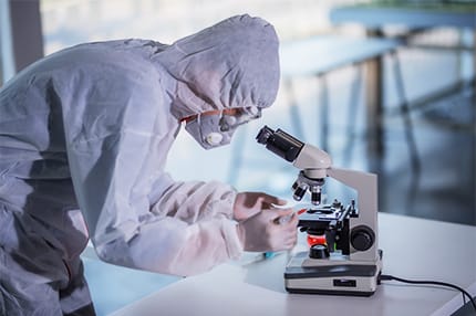 EHS Technician Using Microscope