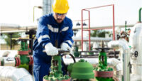 Man Monitoring Industrial Energy Source