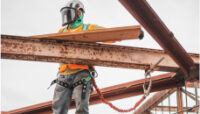 Worker on Construction Site Building Infrastructure with Safety Precautions